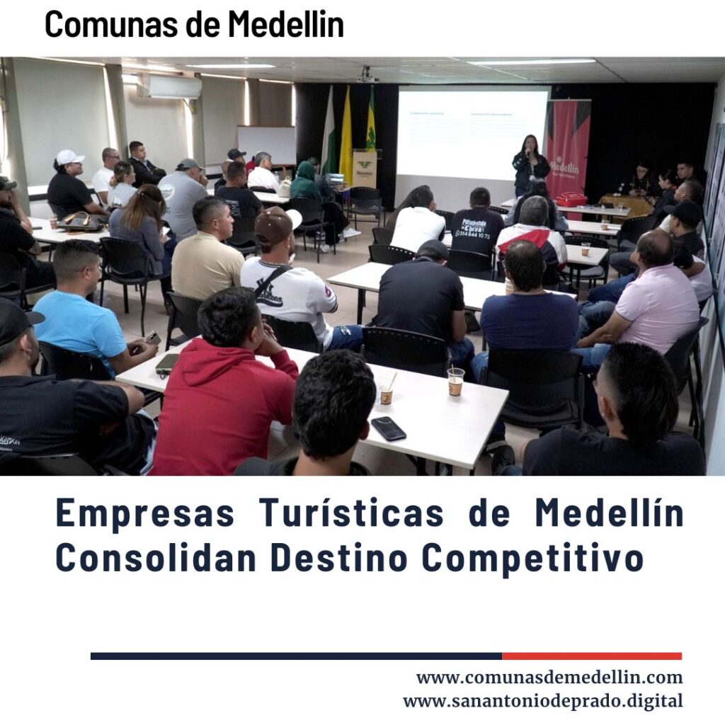 Grupo de empresarios y participantes en una capacitación turística en una sala de Medellín, atentos a una presentación en proyector sobre fortalecimiento empresarial, con banderas de Colombia y Medellín al fondo, promoviendo el sector turístico competitivo de la ciudad.
