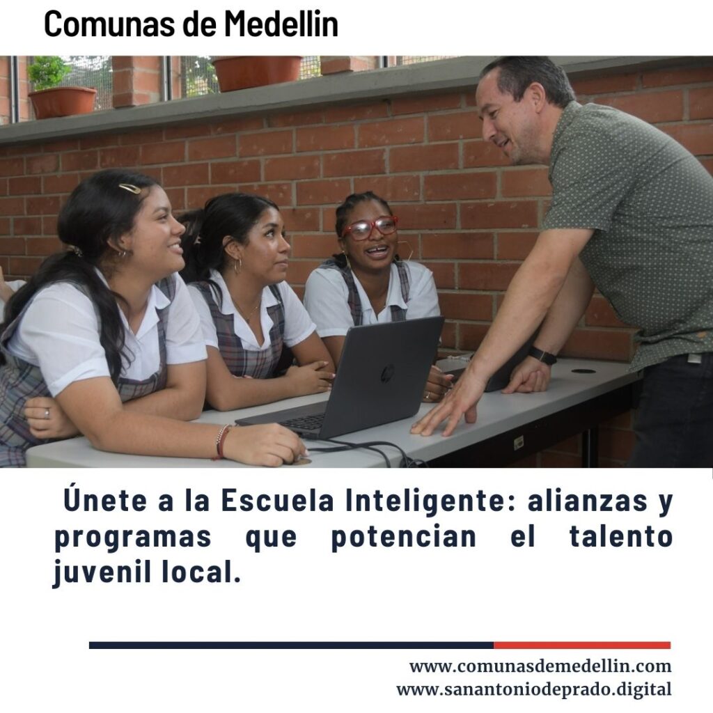 Profesor guiando a tres estudiantes uniformadas en una actividad con laptop, promoviendo la Escuela Inteligente con alianzas y programas que potencian el talento juvenil local en Medellín.
