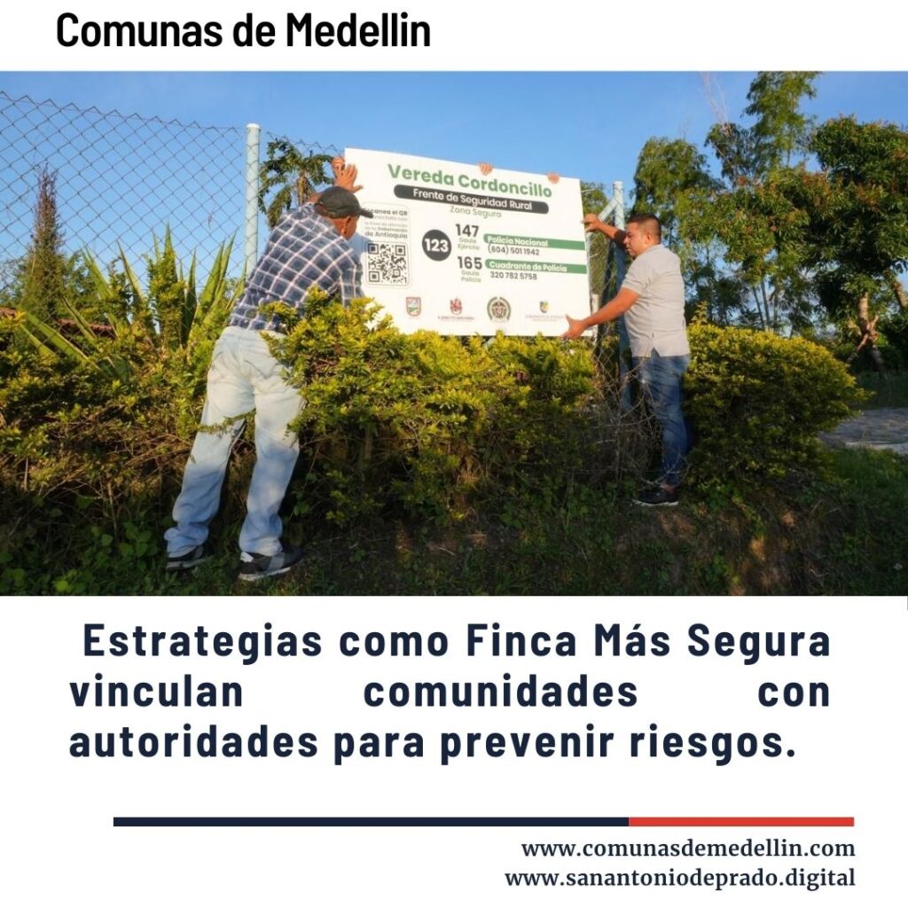 Dos hombres instalando un cartel de seguridad rural en la Vereda Cordoncillo, Frente Cordoncillo 147, como parte de la estrategia Finca Más Segura en las Comunas de Medellín para vincular comunidades con autoridades y prevenir riesgos.